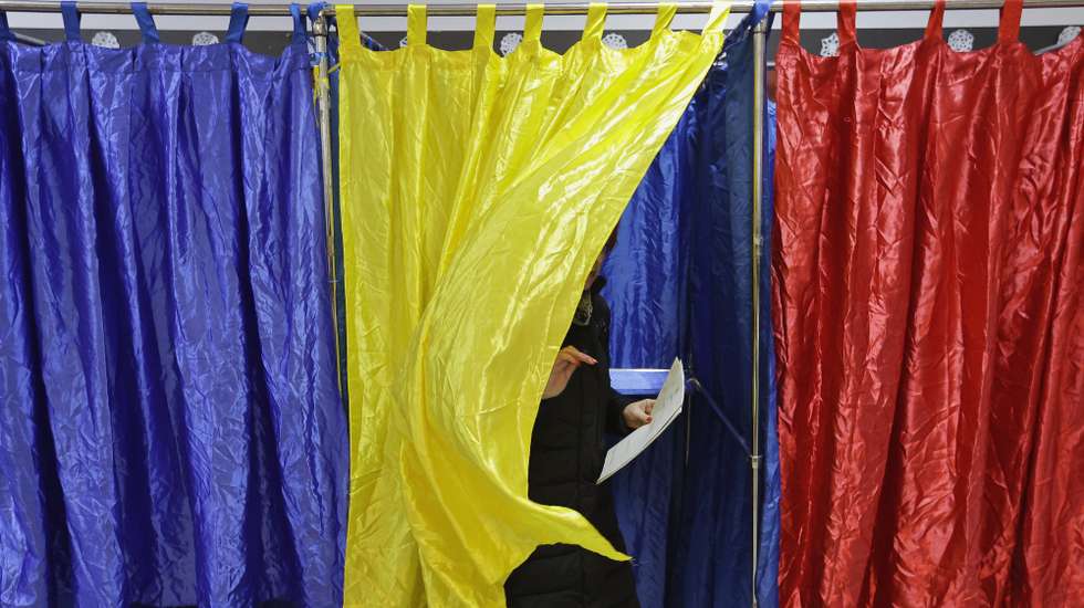 epaselect epa11751722 A Romanian woman exits the voting booth after stamping her ballot during the parliamentary elections at Cezar Bolliac Primary School polling station in Bucharest, Romania, 01 December 2024. Approximately 18 million Romanian citizens are expected at the polling stations this weekend for choosing the bicameral parliament members, according to the Permanent Electoral Authority (AEP), of which 989,230 people can express their intention abroad.  EPA/ROBERT GHEMENT