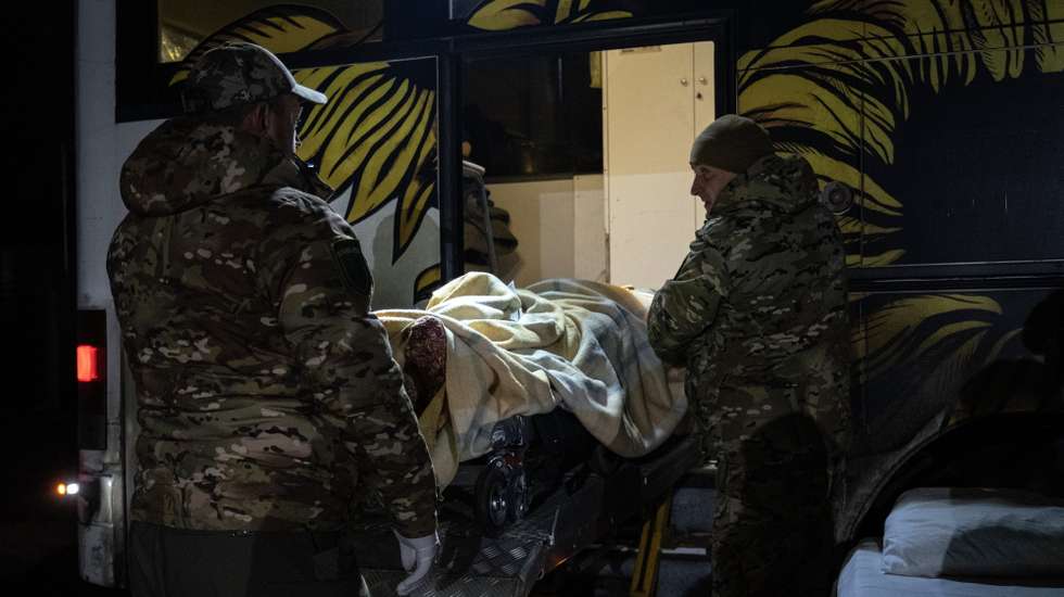 epa11764324 Medical staff of the Hospitallers carry a wounded Ukrainian soldier into their medical bus for transport to a hospital, in the Donetsk region, Ukraine, 06 December 2024 (issued 08 December 2024). The Hospitallers, a Ukrainian volunteer medical battalion, has been providing medical care to Ukrainian soldiers wounded in combat since 2014. The medical battalion's current operations include evacuating patients from medical points near the front line in Donetsk to secure referral hospitals in the Dnipro region.  EPA/MARIA SENOVILLA