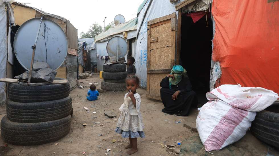 epa11967182 A displaced Yemeni woman (R) sits with her children outside their shelter at a makeshift camp for Internally Displaced Persons (IDPs) in Sana'a, Yemen, 15 March 2025. The World Food Programme (WFP) has issued a warning about the escalating hunger crisis in war-ravaged Yemen, where over 17.6 million people out of the country's 30-million population could be severely food insecure in 2025. According to the United Nations, Yemen remains one of the world's most complex humanitarian crises, with over four million people displaced due to prolonged conflict and economic instability.  EPA/YAHYA ARHAB