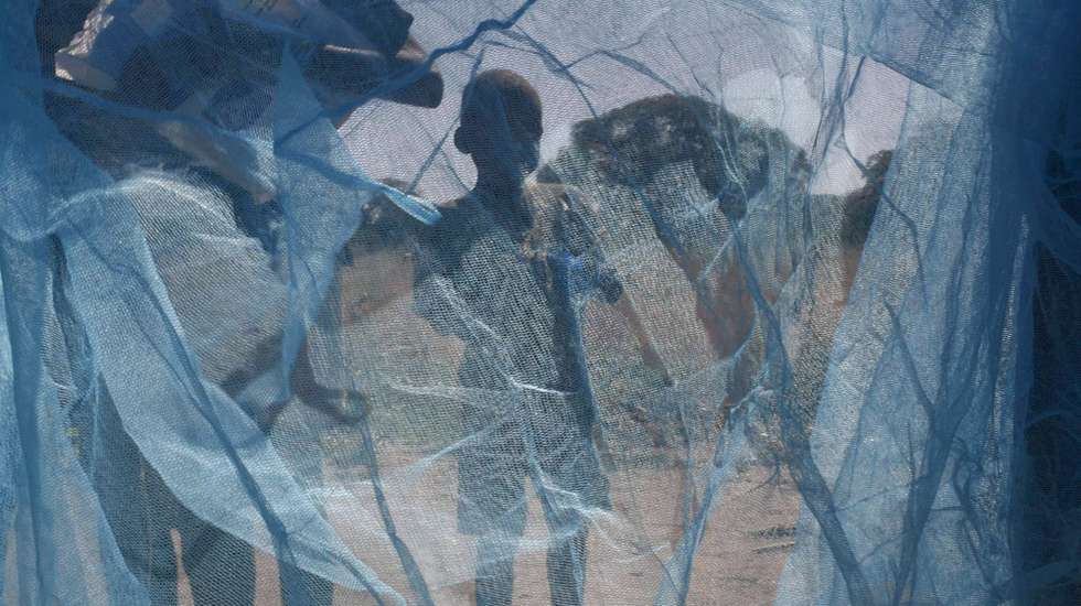 epa01323995 A young boy hopes to get a hand out mosquito net given to his village by members of the Roll Back Malaria Expedition at a village on the Zambezi River near Livingston, Zambia, 23 April 2008.  The Roll Back Malaria Expedition is traveling down the Zambezi River from it's source in Angola so as to hand out malaria nets and educational talks to villagers along the river banks. World Malaria Day will be marked on Friday 25 April.  EPA/KIM LUDBROOK