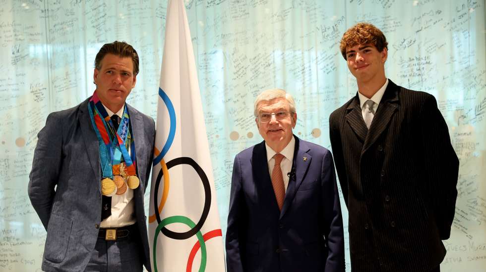 epa12074694 US swimmer Gary Hall Jr. with IOC President Thomas Bach and his son Charles after he was presented with replicas of his ten Olympic medals that he lost during the wildfires in Los Angeles that destroyed his home earlier this year during a ceremony at the Olympic House in Lausanne, Switzerland, 05 May 2025.  EPA/Denis Balibouse / POOL POOL, EDITORIAL USE ONLY