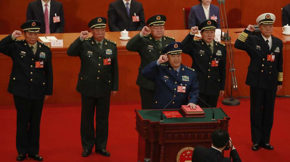 epa06611374 Newly elected vice chairmen of the Central Military Commission (CMC) Xu Qiliang (front C) and Zhang Youxia (2nd row 3-L), members of the CMC Zhang Shengmin (2nd row L), Li Zuocheng (2nd row 2-L), Wei Fenghe (2nd row 2-R) and Miao Hua (2nd row R) swear an oath on the constitution during the 6th plenary session of the first session of the 13th National People's Congress (NPC) at the Great Hall of the People in Beijing, China, 18 March 2018. Delegates of the NPC vote on 18 March to decide on the appointment of the premier, and vice chairpersons of the Central Military Commission (CMC). The NPC has over 3,000 delegates and is the world's largest parliament or legislative assembly though its function is largely as a formal seal of approval for the policies fixed by the leaders of the Chinese Communist Party. The NPC runs alongside the annual plenary meetings of the Chinese People's Political Consultative Conference (CPPCC), together known as 'Lianghui' or 'Two Meetings'.  EPA/HOW HWEE YOUNG