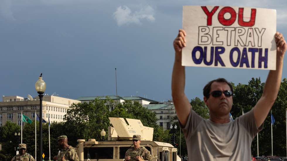 epaselect epa12301247 A protester stands in front of National Guard troops stationed in front of Union Station in Washington, DC, USA, 14 August 2025. US President Donald Trump, for the first time in history, has activated approximately 800 members of the District of Columbia National Guard along with federal agents from the FBI, DEA, ICE and Homeland Security Investigations (HSI), to join the federalized Metropolitan Police Department in policing the city.  EPA/ANNA ROSE LAYDEN