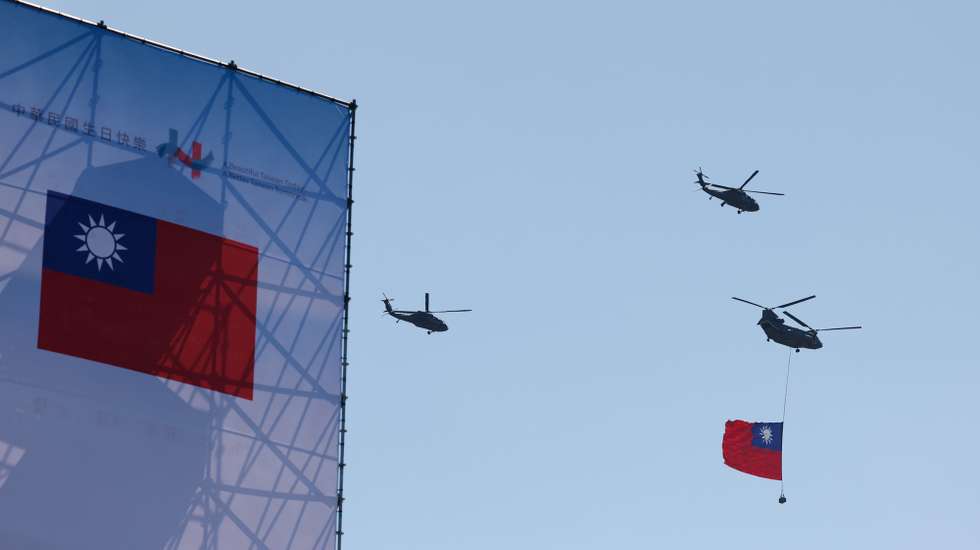 epa12443778 Taiwan Chinook helicopter carrying a giant Taiwan flag, fly past during Taiwan's National Day celebrations outside the Presidential office building in Taipei, Taiwan, 10 October 2025.
Taiwan's National day, also known as Double Ten Day, is celebrated annually on 10 October.  EPA/RITCHIE B. TONGO