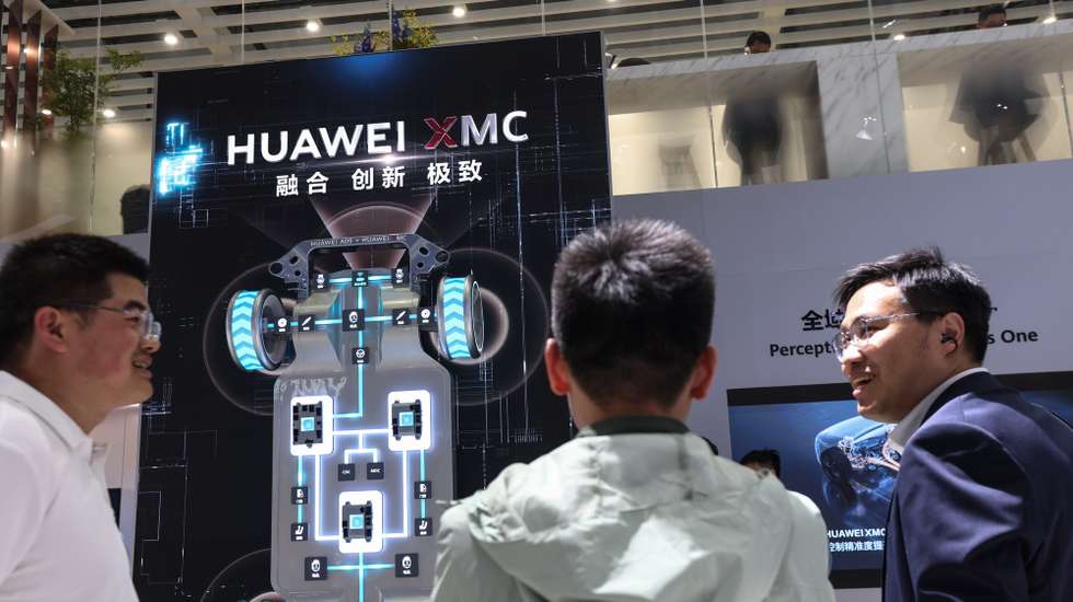 epa12912816 Visitors chat at the Huawei stand of the 2026 Beijing International Automotive Exhibition in Beijing, China, 25 April 2026. The Beijing International Automotive Exhibition is held in Beijing every two years and it goes from 24 April until 03 May.  EPA/WU HAO