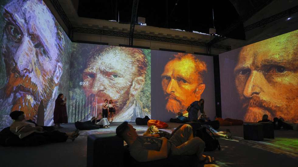 epaselect epa13044949 Visitors attend the immersive exhibition 'Van Gogh's Universe' in Kyiv, Ukraine, 17 June 2026, amid the Russian invasion. Making its debut in the Ukrainian capital, the international multimedia display utilizes Digital Art 360 technology to map animated versions of Dutch Post-Impressionist painter Vincent van Gogh's iconic works onto the floors and walls of the gallery space.  EPA/SERGEY DOLZHENKO