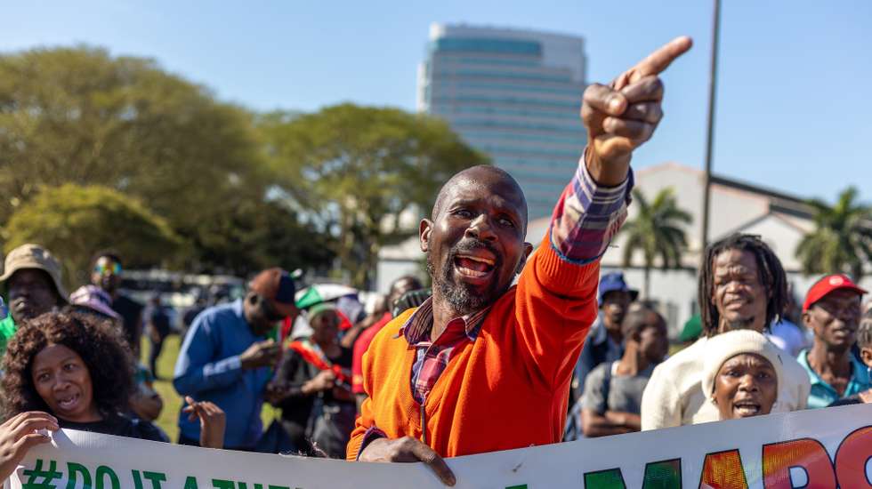 epa13175846 Supporters of the anti-immigration group 'March and March' protest outside the 46th Ordinary SADC Summit of Heads of State and Government at the Durban International Conference Centre in Durban, South Africa, 17 August 2026. The anti-migrant group called on the SADC leaders whose citizens are living in South Africa without proper documentation to 'Come fetch your people.' The controversial anti-migrant movement has led protests calling for undocumented foreign nationals to leave South Africa, including a nation wide shut down on 30 June 2026.  EPA/STRINGER