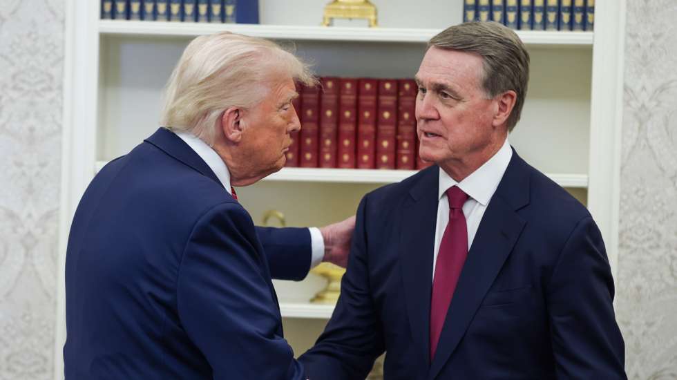 epa12081639 US President Donald Trump (L) shakes hands with US Senator David Perdue before swearing him in as the United States Ambassador to the Peoples Republic of China in the Oval Office at the White House in Washington, DC, USA, 07 May 2025.  EPA/SAMUEL CORUM / POOL