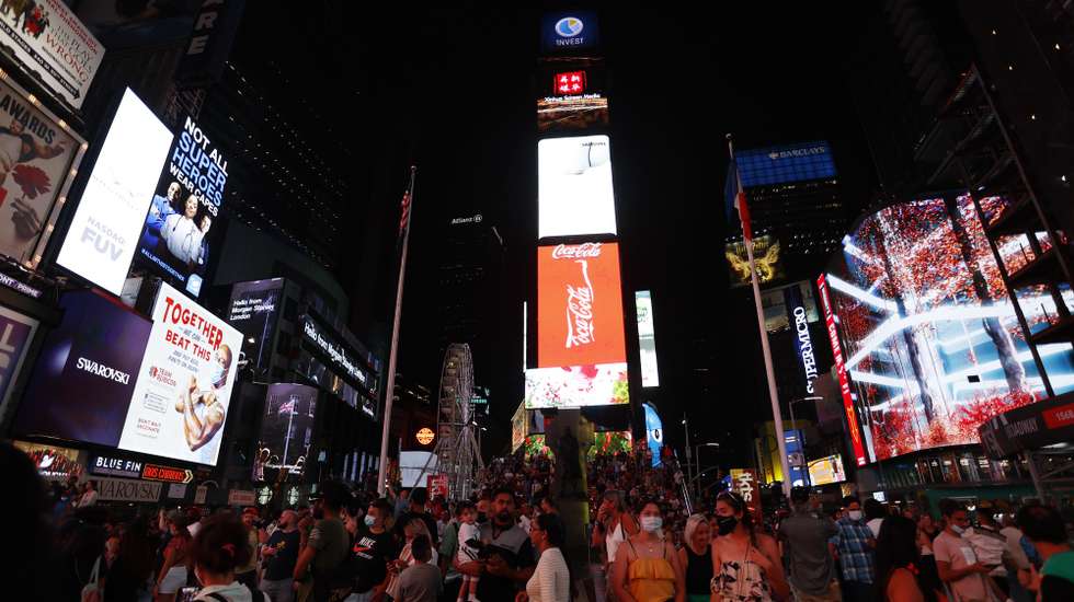 epa09429723 A general view of Times Square and the 110 feet (33.5 meters) tall Times Square Wheel, a ferris wheel which was constructed in Times Square in New York, New York, USA, 25 August 2021. The attraction will operate until 12 September.  EPA/JASON SZENES
