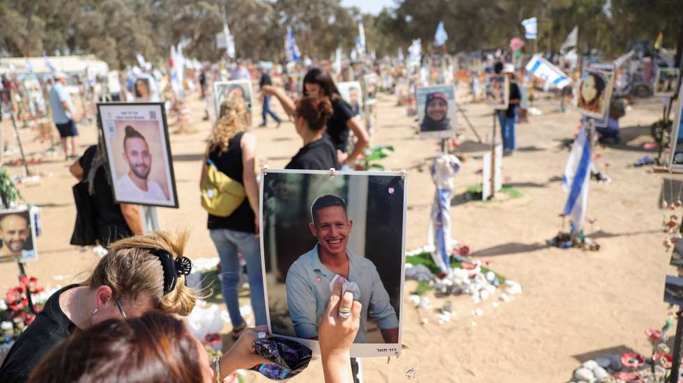 epa11641458 A woman cleans a relative picture and memorials for Israeli festival goers who were killed by Hamas at the site of the Supernova Music Festival rave  near Kibbutz Reim, Southern Israel, 19 September 2024. On 7 October 2023, the Palestinian group Hamas launched a coordinated attack from Gaza into Israel, with thousands of rockets fired and with militants’ staging land incursions into kibbutz communities and cities. The participants of the Nova music festival were also among other targets in the area of southern Israel bordering Gaza. 
The unprecedented attack was followed by an air and land offensive of the Israeli Army in the Gaza Strip, with massive displacement of its population and tens of thousands killed in almost one year of conflict.
According to Israeli official sources, 1,139 people were killed in the Hamas attack including 695 Israeli civilians and 71 foreigners as well as 373 members of the security forces. Hamas militants also took 251 hostages, 117 of which have been released alive with 37 dead. The rest remain in captivity.
After one year of war, the death toll reached 1,638 in Israel, among them 860 civilians, according to the National Insurance Office.  EPA/ABIR SULTAN  ATTENTION: This Image is part of a PHOTO SET