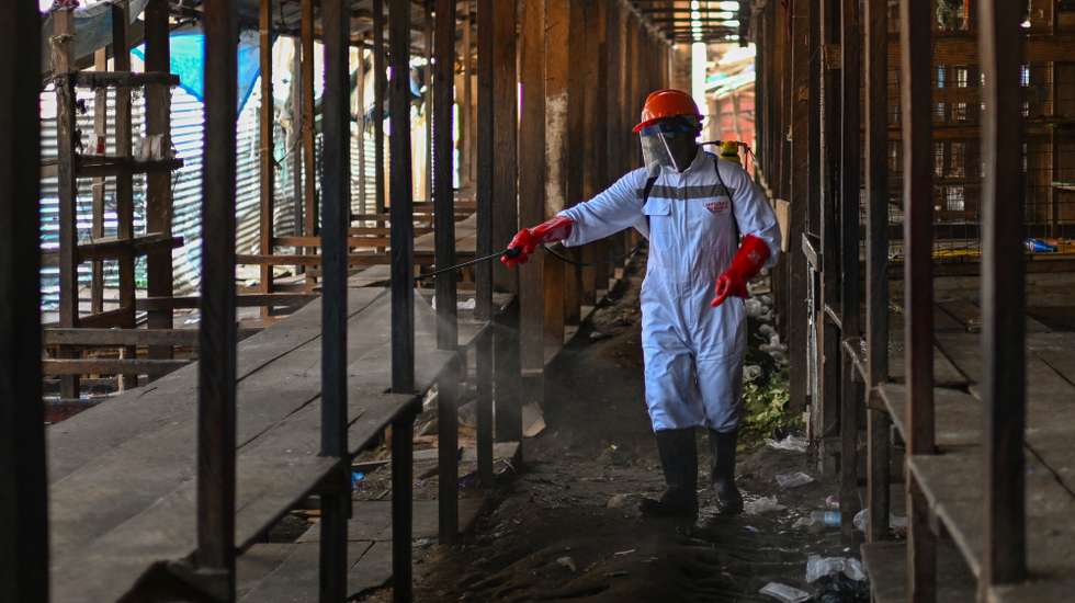 epa12986968 A sanitation worker wearing protective gear disinfects market stalls at a wet market in Bunia, Ituri province, Democratic Republic of the Congo, 23 May 2026, as part of containment measures to halt the spread of the Ebola virus. The World Health Organization (WHO) recently raised the national risk level to 'very high' following a surge in cases. The outbreak, officially declared by the DRC Ministry of Health on 15 May, is driven by the Bundibugyo strain of the virus, for which there are currently no approved vaccines or specific therapeutic treatments.  EPA/STRINGER