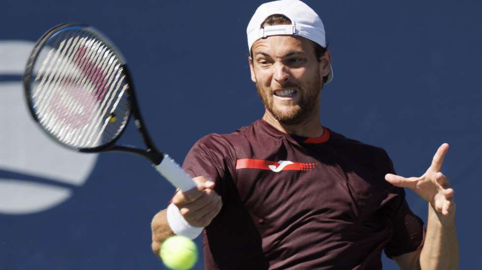epa10153260 Joao Sousa of Portugal returns the ball to Cameron Norrie of England in their second round match during the US Open Tennis Championships at the USTA National Tennis Center in in Flushing Meadows, New York, USA, 01 September 2022. The US Open runs from 29 August through 11 September.  EPA/CJ GUNTHER