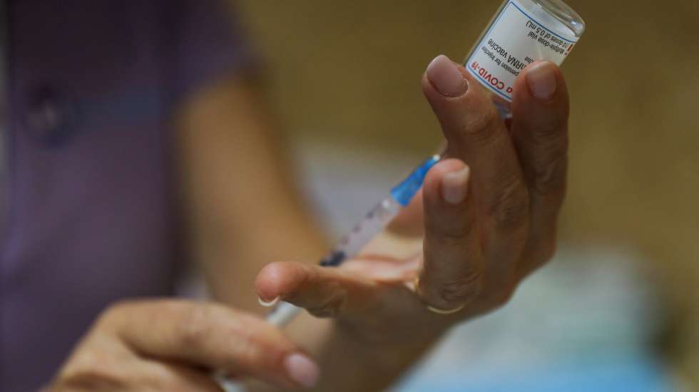 Uma enfermeira prepara uma dose da vacina da Moderna no Centro de Vacinação do Seixal, 7 de abril de 2021. MIGUEL A. LOPES/LUSA