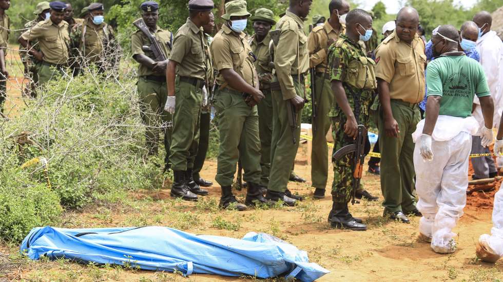 epa10588063 Kenyan homicide detectives and forensic experts from the Directorate of Criminal Investigations (DCI), examine exhumed bodies from several shallow mass graves of suspected members of a Christian cult after starving themselves to death, after allegedly being told by their controversial preacher Paul Mackenzie that they would go to heaven if they starved themselves to death, in the coastal Shakahola forest, in Kilifi, Kenya, 23 April 2023. According to the Police, 18 more bodies were exhumed on 23 April bringing the tally of bodies recovered to at 39.  EPA/STR