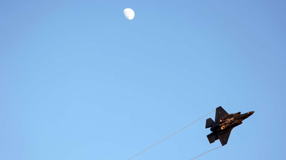 epa10717822 Israeli Air Force F-35  fighter aircraft flies next to the moon during an air show at the graduation ceremony of new combat fighter pilots of the Israeli Air Forces at the Hatzerim Air Force base, outside Beersheva, in southern Israel, 29 June 2023.  EPA/ABIR SULTAN