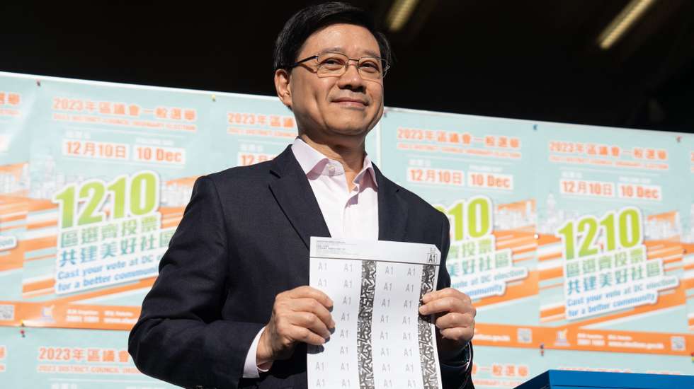 epa11020592 Hong Kong Chief Executive John Lee casts his vote for the District Council Ordinary Election in Hong Kong, China, 10 December 2023. This is the first election after its reform in May 2023 which aims at ensuring only 'patriots' are elected. The directly elected seats will be slashed to around 20 percent under the electoral overhaul.  EPA/Bertha WANG