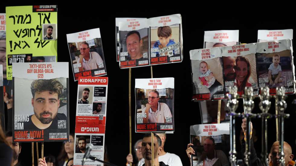 epa11019781 Family members and supporters of Israeli hostages held by Hamas in Gaza, hold up portraits and call for their release during a protest outside the Kirya military base in Tel Aviv, Israel , 09 December 2023. According to the Israeli army 137 Israelis are still held hostage in Gaza.  EPA/ABIR SULTAN