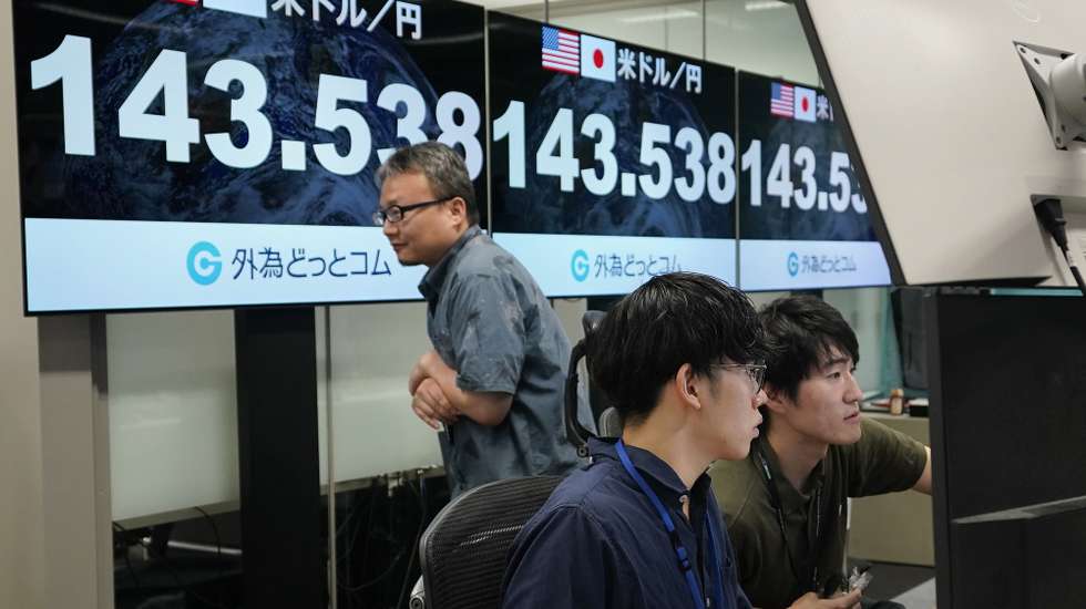 epa11526616 Dealers work next to monitors showing the foreign exchange rate between the Japanese yen and US dollar in Tokyo, Japan, 05 August 2024. The Tokyo stock exchange plunged more than 11 percent, with the Japanese yen rising against the US currency, after a drop on Wall Street of more than 600 points.  EPA/KIMIMASA MAYAMA