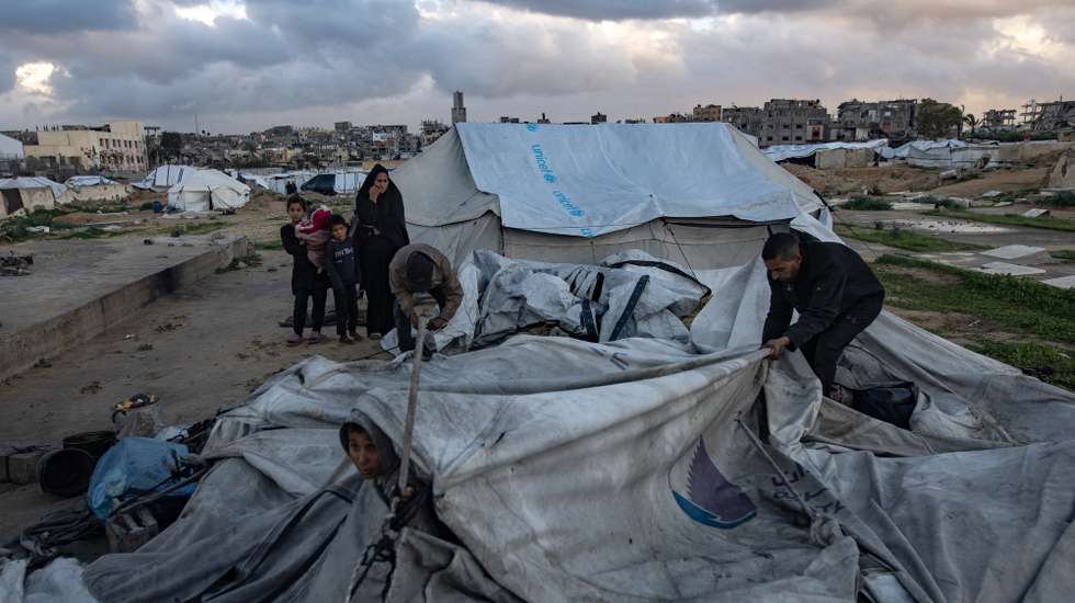epa12639019 A Palestinian family is trying to gather what remains of their belongings after their tent was damaged in Khan Younis in the southern Gaza Strip, 09 January 2026. The tent sheltering the Palestinian family was destroyed by strong winds and heavy rain, leaving the family without shelter.  EPA/HAITHAM IMAD