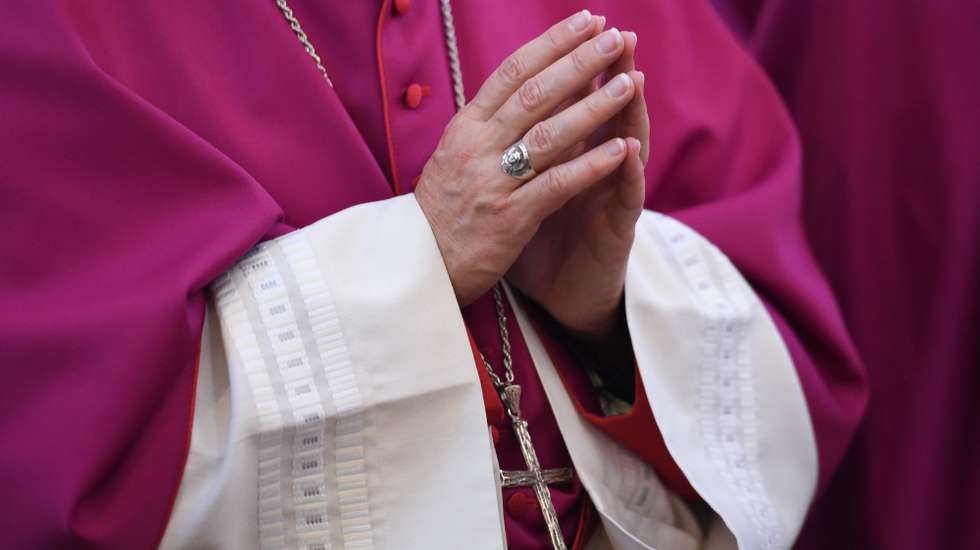 epa04943219 A member of the German Bishops' Conference with his hands folded for prayer during the opening church service at the autumn conference of the clerical institution in the cathedral of Fulda, Germany, 22 September 2015. The Catholic bishops will discuss the ongoing refugee crisis in Europe among other issues during the traditional meeting.  EPA/ARNE DEDERT