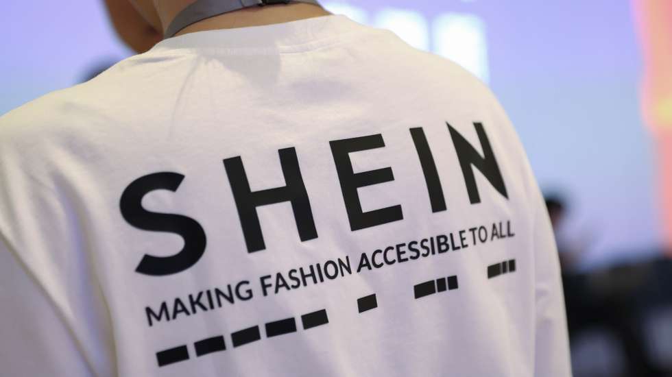 epa13203512 A person wearing a shirt with a SHEIN logo takes part in SHEIN’s listing ceremony at the Hong Kong Exchanges and Clearing Limited (HKEX) in Hong Kong, China, 01 September 2026.  EPA/MAY JAMES