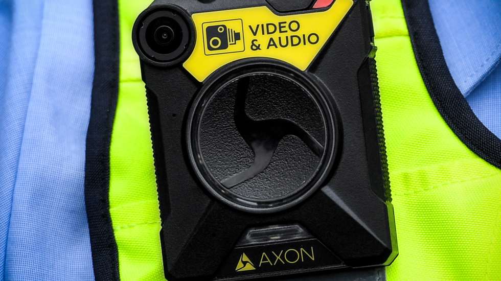 epa07868790 Police officers present new introduced bodycams (L) for North Rhine-Westphalian police in Cologne, Germany, 25 September 2019. The de-escalating effect of the bodycams is intended to protect police officers from attacks in patrol service.  EPA/SASCHA STEINBACH