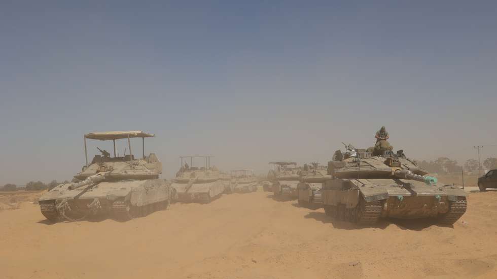 epa11319693 Israeli armoured vehicles gather along the border fence with southern Gaza Strip, Israel 05 May 2024. More than 34,550 Palestinians and over 1,455 Israelis have been killed, according to the Palestinian Health Ministry and the Israel Defense Forces (IDF), since Hamas militants launched an attack against Israel from the Gaza Strip on 07 October 2023, and the Israeli operations in Gaza and the West Bank which followed it.  EPA/ABIR SULTAN