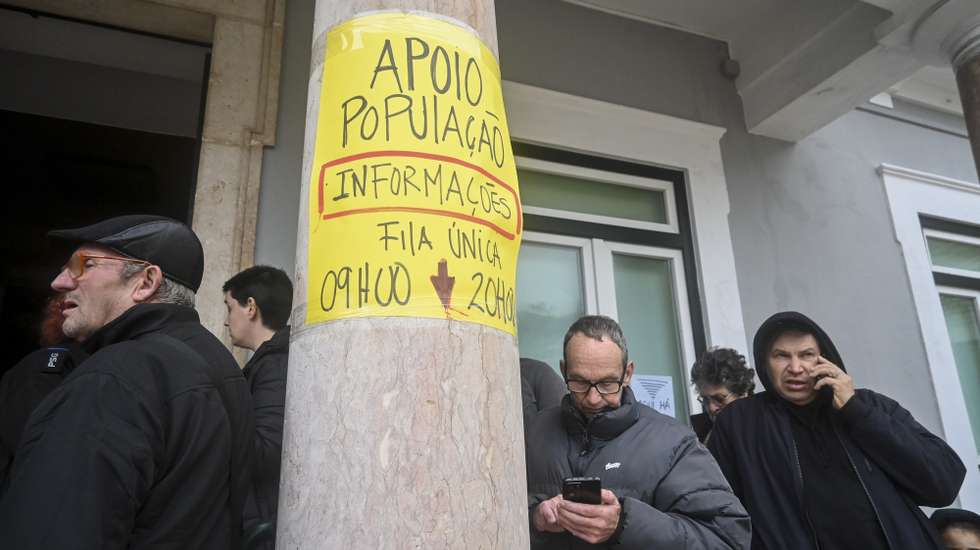 People wait outside the Marinha Grande Town Hall to obtain information, charge their cell phones, and communicate aftermath Kristin depression on Wednesday in Marinha Grande, Leiria, Portugal, 30 January 2026. The passage of depression Kristin through Portuguese territory left a trail of destruction, causing five deaths and leaving several people homeless. CARLOS BARROSO/LUSA