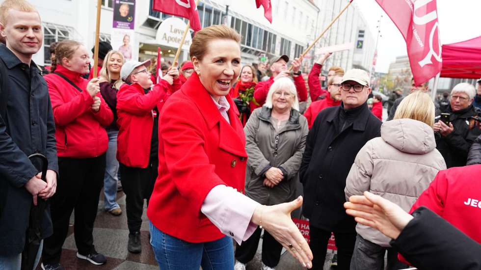 epa12846009 Denmark's Prime Minister and Social Democrats leader Mette Frederiksen (C) greets people on election day on the street at Nytorv in Aalborg, Denmark, 24 March 2026.  EPA/Henning Bagger  DENMARK OUT