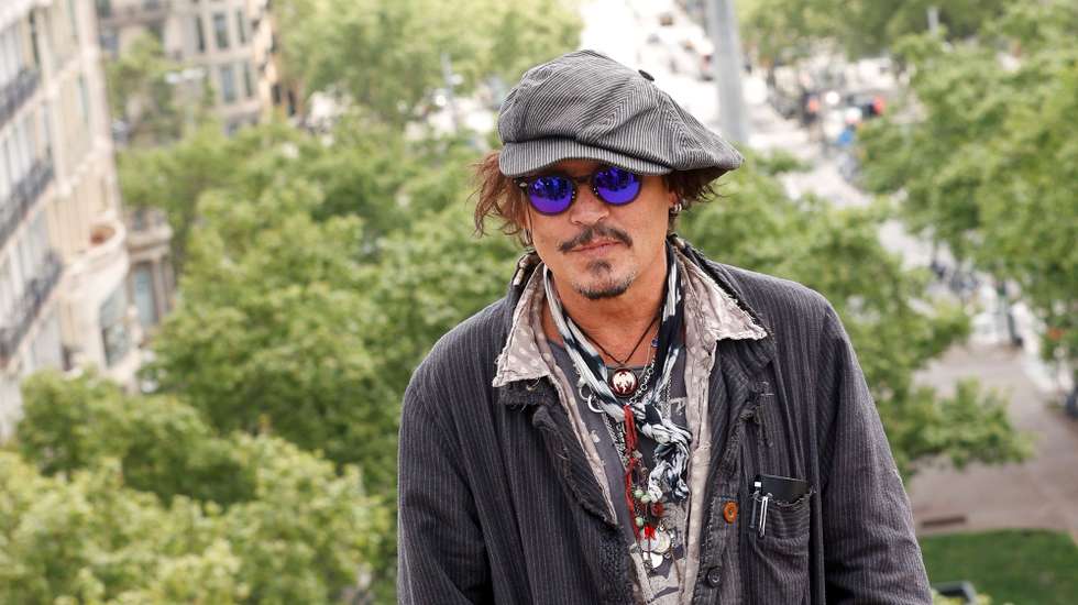 epa09139627 US actor Johnny Depp poses for photographers during the presentation of his film 'The Photographer from Minamata', in Barcelona, Spain, 16 April 2021. The movie airs on April 30 and goes through the life story of popular US photographer Eugene Smith.  EPA/Quique Garcia