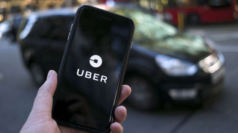 epa09023553  (FILE) - An Uber logo on a mobile telephone in central London, Britain, 22 September 2017 (re-issued 19 February 2021). The UK Supreme Court on 19 February 2021 ruled the Uber drivers are not not self-employed but workers. Uber, that has some 45,000 drivers working in London and that lost earlier court cases, said it would contact its active drivers across UK and discuss the operations. The ruling could mean Uber drivers may be entitled to holiday payments and minimum wages.  EPA/WILL OLIVER *** Local Caption *** 55660504