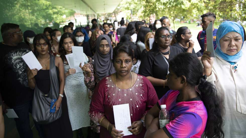 epa10587386 Leela (C), sister of death row inmate Tangaraju Suppiah, stands with family members and supporters as they prepare to walk to the Istana, or Presidential Palace to submit letters appealing for the President to grant him clemency in Singapore, 23 April 2023. Tangaraju Suppiah is scheduled for execution on 26 April 2023 after being convicted for abetting an attempt to traffic one kilogram of cannabis, in the country’s first capital punishment to be carried out in the year. Family members and supporters attending a solidarity event for Tangaraju on 23 April walked to the Istana and submitted 59 letters appealing to Singapore’s President Halimah Yacob to grant him clemency. The family also called for the courts to review his death sentence and conviction. The case has reignited debate in the city state on capital punishment amid concerns by activists on the fairness of his trial and conviction.  EPA/HOW HWEE YOUNG