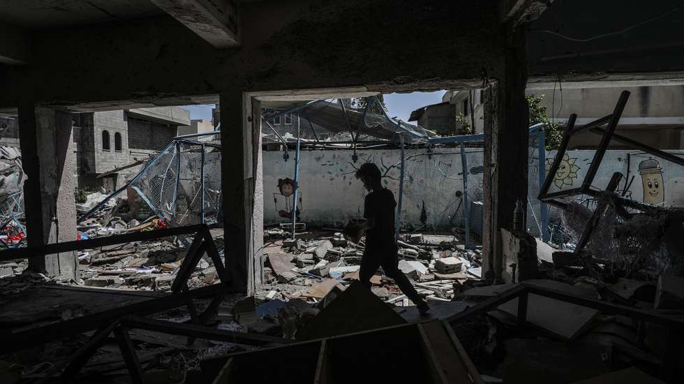epa11600152 An internally displaced Palestinian boy walks among the rubble at the UNRWA-run school-turned-shelter of al-Jaouni, a day after the structure was hit by an Israeli airstrike, in Al-Nusairat refugee camp, central Gaza Strip, 12 September 2024. According to the Palestinian Ministry of Health in Gaza, at least 18 Palestinians were killed and dozens were injured in the strike. The United Nations agency for Palestine refugees (UNRWA) said at least six of their workers were among the victims. The Israeli military stated that it conducted a 'precise strike' on militants operating inside a Hamas command and control center in the area of Nuseirat in central Gaza. More than 41,000 Palestinians and over 1,400 Israelis have been killed, according to the Palestinian Health Ministry and the Israel Defense Forces (IDF), since Hamas militants launched an attack against Israel from the Gaza Strip on 07 October 2023, and the Israeli operations in Gaza and the West Bank which followed it.  EPA/MOHAMMED SABER