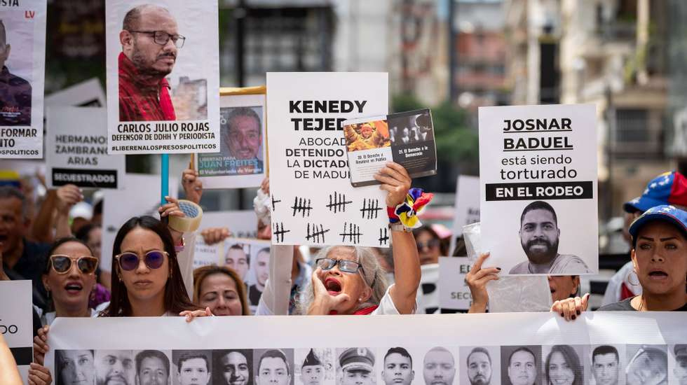 epa11599467 A woman chants slogans during a protest by family members of political prisoners in Venezuela; in Caracas, Venezuela, 11 September 2024.  EPA/RONALD PENA R