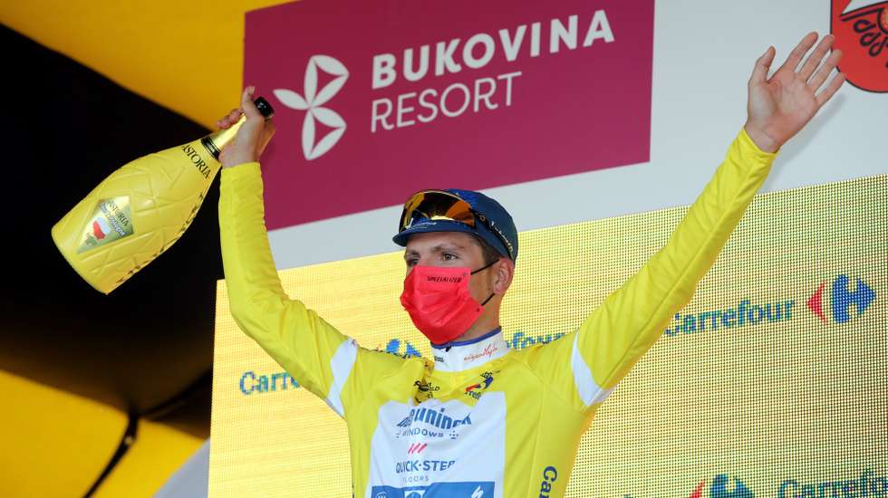 epa09411467 The overall leader Portugal cyclist Joao Almeida of Deceuninck-Quick Step celebrates on the podium after winning the fourth stage of the 78th Tour de Pologne 2021 cycling race over 160 km, from Tarnow to Bukowina Tatrzanska, in Bukowina Tatrzanska, south Poland, 12 August 2021.  EPA/Grzegorz Momot POLAND OUT