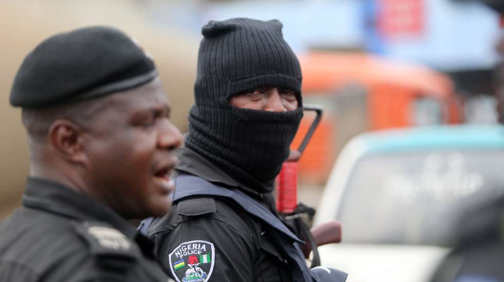epa09534457 A policeman is seen wearing a hood during a memorial protest for a military attack at the Lekki tollgate in Lagos, Nigeria, 20 October 2021. Police disperse youths who held a memorial protest in Lagos to commemorate a military attack during the protest against police brutality on 20 October 2020.  EPA/AKINTUNDE AKINLEYE