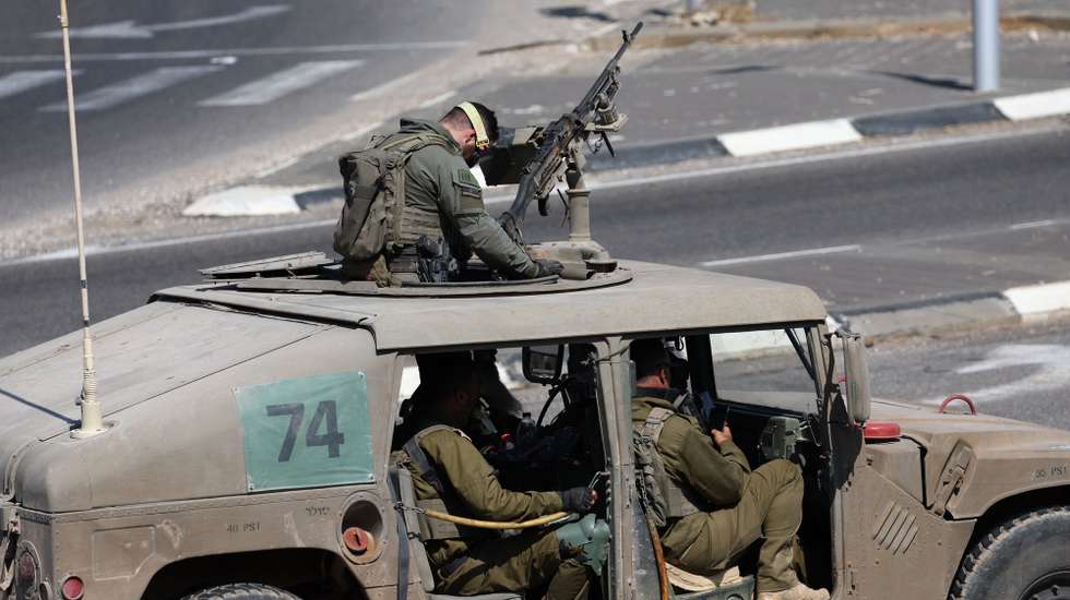 epa11654670 Israeli soldiers aboard a military vehicle at an undisclosed location, near the border with Lebanon in northern Israel, 11 October 2024. Israel's military stated on 11 October, that an anti-tank missile fired from Lebanon crossed into Israel and fell in the area of Yir'on, injuring two civilians.  EPA/ATEF SAFADI