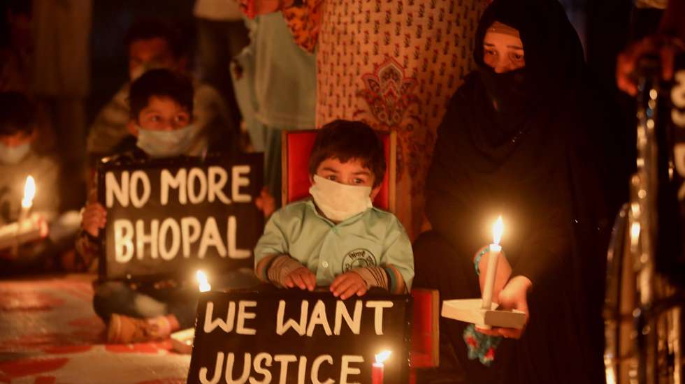 epa08854859 Indian children with congenital disabilities that are believed were caused by the exposure of their parents to gas leakage during the Union Carbide gas leak disaster, along with their relatives and supporters, take part in a candle light vigil to pay homage to the people killed in the 1984 Bhopal gas tragedy to mark the 35th anniversary of the disaster, in Bhopal, India, 01 December 2020. A gas leak at a Union Carbide Corporation plant in Bhopal on the intervening night of 02 and 03 December 1984 killed at least 15,000 people in what is considered as one of the world's most significant industrial accidents.  EPA/SANJEEV GUPTA