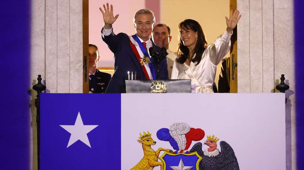 epa12813260 Chilean President Jose Antonio Kast (L) waves alongside his wife, Maria Pia Adriasola (R), from the balcony of the Moneda Palace in Santiago, Chile, 11 March 2026. In his first speech as president to the nation, Kast said he had inherited a country 'in worse condition than he could have imagined' and with 'weakened public finances.'  EPA/Elvis Gonzalez