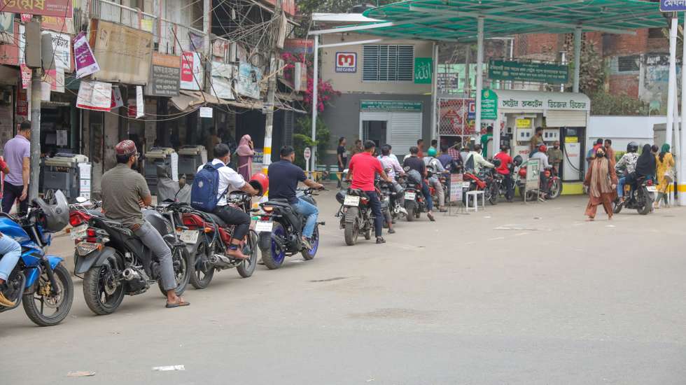 epaselect epa12808771 People queue with their motorcycles at a fuel station in Dhaka, Bangladesh, 10 March 2026. Dhaka and other parts of the country have faced unusually long queues at petrol pumps in recent days; this comes after the recent conflict in the Middle East. According to the Bangladesh Petroleum Corporation (BPC), ride-sharing motorbikes will now be allowed to purchase up to 5 liters of fuel per day from filling stations, increased from the previous limit of 2 liters per day.  EPA/MONIRUL ALAM