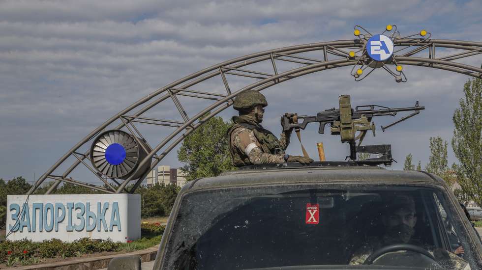 epa09921713 A picture taken during a visit to Mariupol organized by the Russian military shows Russian servicemen on guard in front of the main entrance of the Zaporizhzhia Nuclear Power Station in Enerhodar, southeastern Ukraine,  01 May 2022. The Zaporizhzhia Nuclear Power Station is under control of the Russian National Guard, the Ukrainian military that guarded the facility handed over their weapons and were released on 09 March according to Andriy Shevchik, head of the Enerhodar city administration. On 24 February Russian troops entered Ukrainian territory in what the Russian president declared a 'special military operation', resulting in fighting and destruction in the country, a huge flow of refugees, and multiple sanctions against Russia.  EPA/SERGEI ILNITSKY