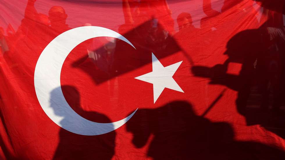 epaselect epa07719258 People shout slogans as they hold Turkish flags during a rally marking the third anniversary of the failed coup attempt, at the Ataturk Airport in Istanbul, Turkey, 15 July 2019. Turkey marks the third anniversary of the failed coup attempt which led to some 50 thousand workers being dismissed, some eight thousand people arrested, and scores of news outlets shut down by the government. Turkish military factions on 15 July 2016 attempted a coup for which Turkish President Recep Tayyip Erdogan blamed US-based Turkish cleric Fethullah Gulen and his movement to allegedly have masterminded the attempt.  EPA/ERDEM SAHIN