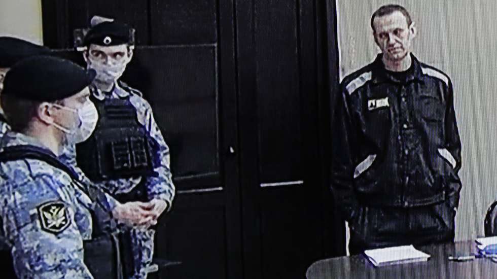 epa09841652 Russian opposition leader and activist Alexei Navalny (R) is seen on a monitor screen during an offsite court session in the penal colony N2 (IK-2) in Pokrov, Vladimir region, Russia, 22 March 2022. The Lefortovo Court of Moscow, at an offsite hearing in correctional colony 2, on March 22 announced the verdict against Russian opposition leader Alexei Navalny in the case of fraud and insulting the court. The founder of the Anti-Corruption Foundation, Alexei Navalny, was poisoned in the summer of 2020 and taken to Berlin for treatment, from where he flew to Moscow in January 2021. Immediately upon his return to Russia, he was detained and arrested. Since March 2021, he has been in a colony in the city of Pokrov, Vladimir Region.  EPA/YURI KOCHETKOV