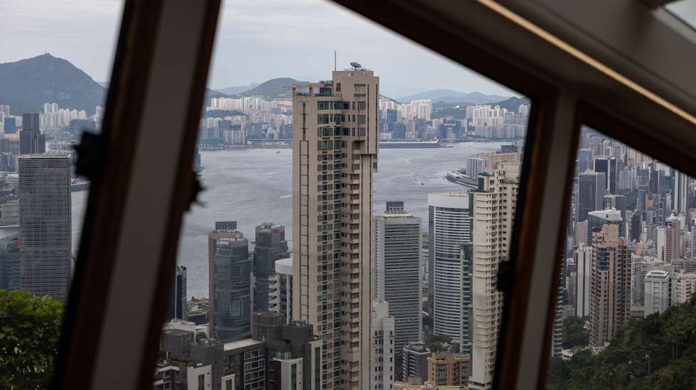 epa10135663 Residential and commercial buildings stand on Hong Kong island and the Kowloon Peninsula as seen from the 6th Generation Peak Tram during an unveiling press preview trip in Hong Kong, China, 24 August 2022. The Peak Tram cars will open to the public on 27 August 2022, after an upgrade project that included the replacement of all haulage, control and signalling systems, ropes and track trails. The new Peak Tram has been manufactured in Switzerland by Garaventa and comprises two cars with a capacity of 210 passengers.  EPA/JEROME FAVRE