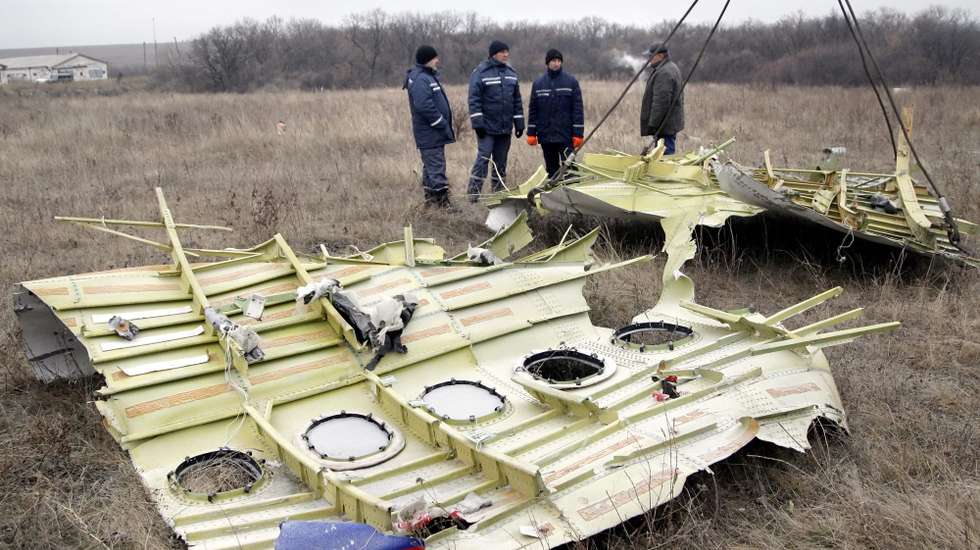 epa04494229 Workers remove parts of the wreckage of Malaysia Airlines passenger jet MH17 at the crash site in rebel-held Grabovo village, about 70 km from Donetsk, Ukraine, 18 November 2014. The Malaysian Airlines plane, which was flying from Amsterdam to Kuala Lumpur, was shot down over Ukraine in July. All 298 people on board were killed. Debris will be transported to the Netherlands for investigation, the Dutch Safety Board said. Access to the site has previously been limited by the rebels, and the ongoing conflict in Ukraine.  EPA/ALEXANDER ERMOCHENKO