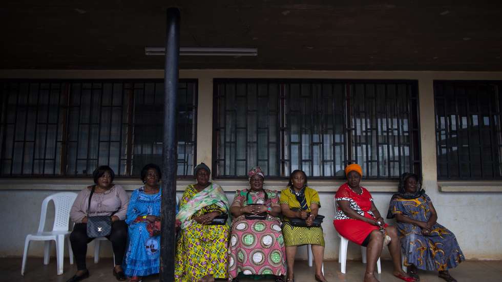epa07077330 Cameroonian women wait to see the results after they cast their ballots at a polling station in the capital Yaounde, Cameroon, 07 October 2018. The incumbent President Paul Biya is Africa's oldest president who has been in power for 36 years. He faces eight candidates with 6.9 million registered voters. Relations between the government and marginalized anglophone separatists in the North West and South West of the country is a major issue threatening peace and stability in Cameroon.  EPA/NIC BOTHMA