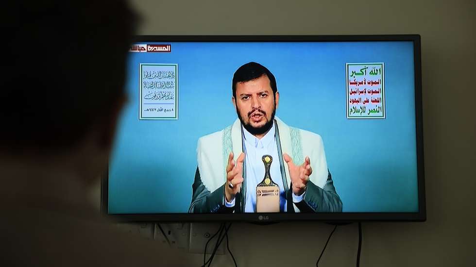 epa12340131 A person watches Houthi leader Abdul-Malik al-Houthi delivering a TV speech, three days after Israeli strikes killed senior Houthi officials, in Sana’a, Yemen, 31 August 2025. Houthi leader Abdul-Malik al-Houthi vowed to continue missile and drone attacks against Israel following the death of Houthi Prime Minister Ahmed Al-Rahawi and several other senior officials in Israeli strikes in Sana’a on 28 August 2025.  EPA/YAHYA ARHAB