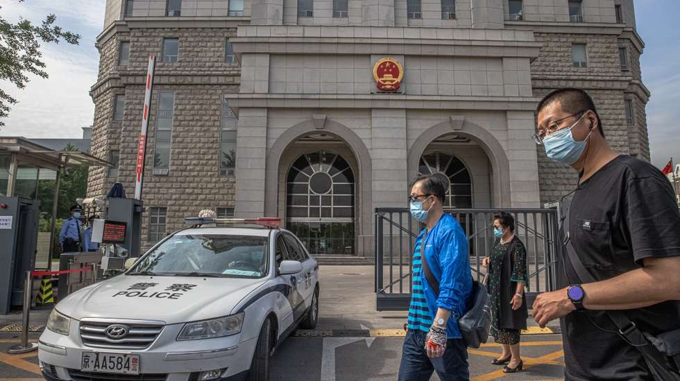 epa11169012 (FILE) - People walk past the Intermediate People's Court where Australian writer Yang Hengjun is expected to face trial, in Beijing, China, 27 May 2021 (reissued 21 February 2024). Hengjun was arrested and imprisoned in China in 2019, on espionage charges. A Beijing court sentenced him in early February 2024 with a suspended death penalty, with the Australian writer refusing to appeal due to illness and disbelief in the Chinese court system, as his family claimed.  EPA/ROMAN PILIPEY *** Local Caption *** 56926124