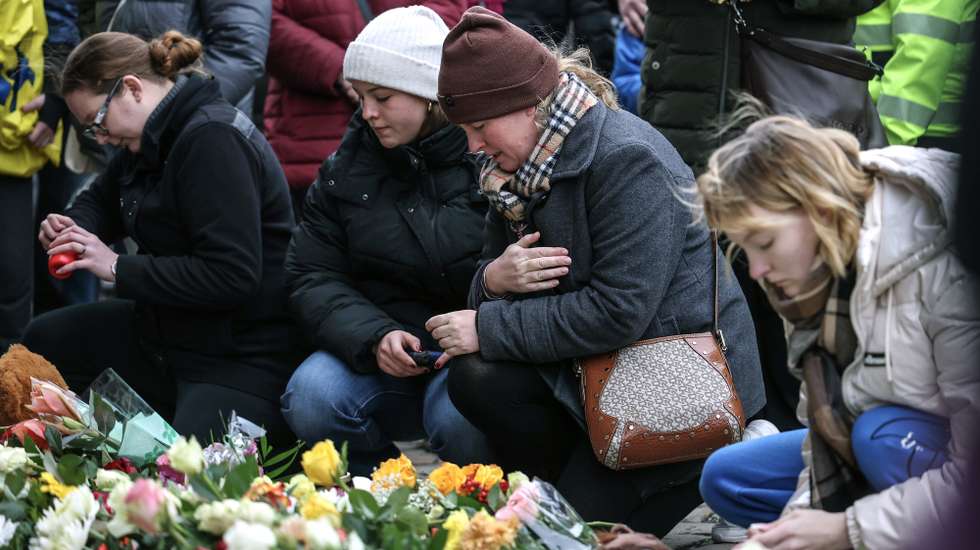 epa11788135 People lay flowers and light candles at the official mourning site in front of St. John's Church, following a vehicle-ramming attack on the Christmas market, in Magdeburg, Germany, 21 December 2024. According to Saxony-Anhalt State Premier Reiner Haseloff, five people were confirmed dead and at least 200 were injured, after a car was driven into a crowd at Magdeburg's Christmas market on 20 December. The suspect, a Saudi national, was taken into custody.  EPA/FILIP SINGER