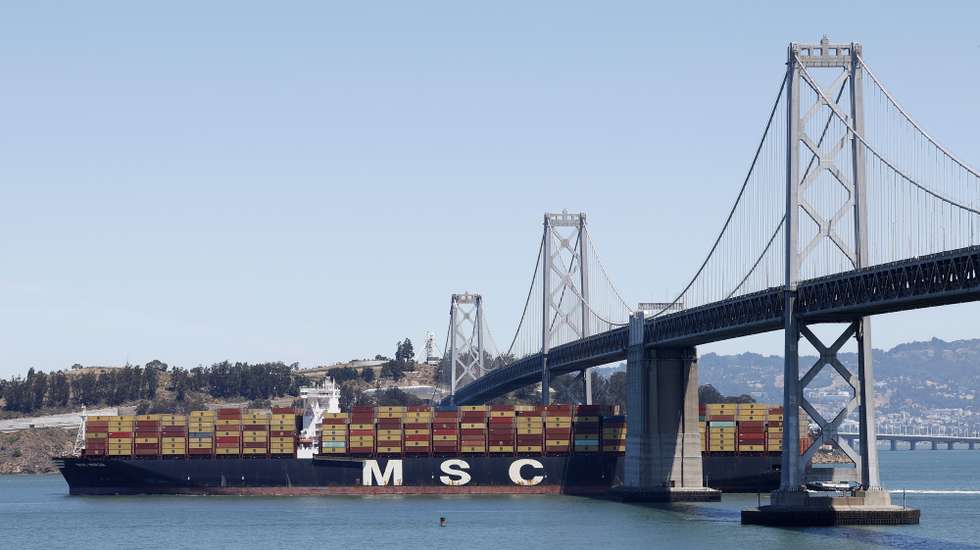 epaselect epa12289188 Container ship MSC Mirja sailing under the flag of Liberia makes its way towards the San Francisco Bay Bridge in San Francisco, California, USA, 07 August 2025. MSC Mirja is in route to Qingdao, China as US President Trump began levying higher import taxes on dozens of countries.  EPA/JOHN G MABANGLO